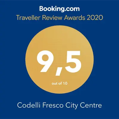 a yellow circle with the number nine and the text travel review awards at Codelli Deluxe Fresco City Centre APP With Balcony in Ljubljana