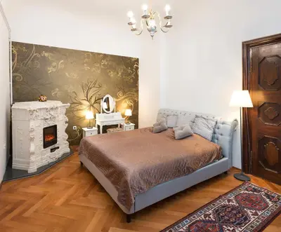a bedroom with a bed and a fireplace at Codelli Deluxe Fresco City Centre APP With Balcony in Ljubljana
