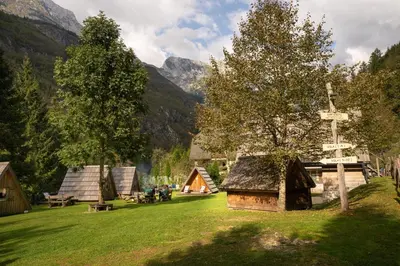 a village with a cross and tents in a field at Camp Korita in Soča