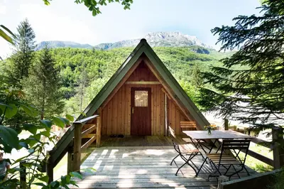 a small cabin with a table and a table at Camp Korita in Soča
