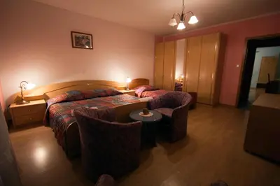 a hotel room with a bed and a couch at Tourist Farm Gregorič in Zalošče