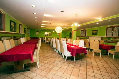 a dining room with red tables and white chairs at Tourist Farm Gregorič in Zalošče