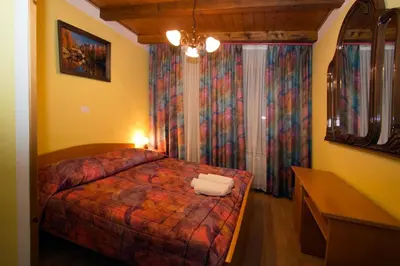 a bedroom with a bed and a dresser in a room at Tourist Farm Gregorič in Zalošče