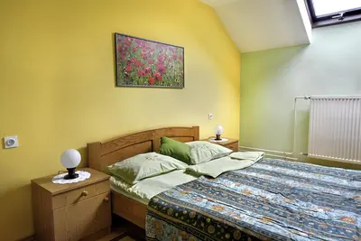 a bedroom with a bed and a painting on the wall at Tourist Farm Ferencovi in Cankova