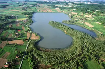 an aerial view of a large lake in a field at Tourist Farm Ferencovi in Cankova