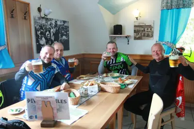 a group of men sitting at a table drinking beer at Guesthouse Veles in Slovenska Bistrica