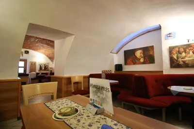 a restaurant with a table and red chairs at Guesthouse Veles in Slovenska Bistrica
