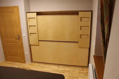 a large wooden garage door in a room at Apartment Appohorje in Pohorje