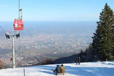 a group of people sitting on top of a snow covered mountain at Apartment Appohorje in Pohorje