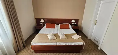 a bedroom with a bed with two pillows on it at Grand Hotel Rogaška Premium in Rogaška Slatina