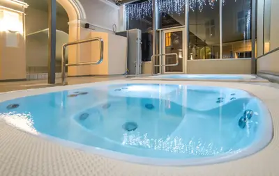 a large blue bath tub in a room at Grand Hotel Rogaška Premium in Rogaška Slatina