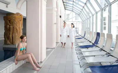 a group of three people in a room with chairs at Grand Hotel Rogaška Premium in Rogaška Slatina