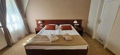 a bedroom with a bed with two towels on it at Grand Hotel Rogaška Premium in Rogaška Slatina