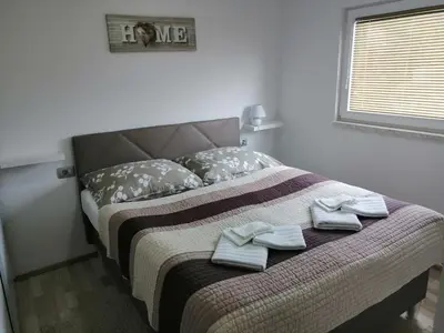 a bedroom with a bed with towels on it at Apartments Ina in Rogaška Slatina