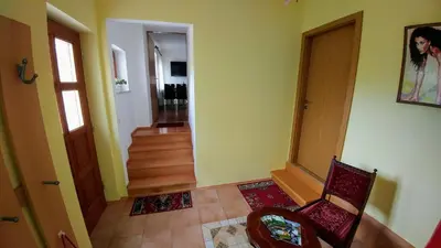 a room with a hallway with a chair and a staircase at Apartments Ina in Rogaška Slatina