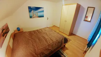 a small bedroom with a bed and a closet at Apartments Ina in Rogaška Slatina