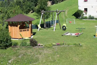a playground with a gazebo in a yard at Apartments Peternelj in Cerkno