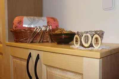 a counter with a table with bowls and utensils on it at Apartments Peternelj in Cerkno