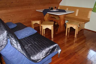 a room with a bed and a table and chairs at Apartments Peternelj in Cerkno