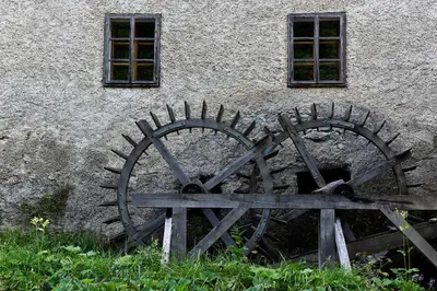 a pair of metalwheels in front of a building at Apartments Kozjanski park in Podsreda