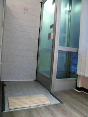 a glass shower door in a room with a floor at Studio Jesenice in Jesenice