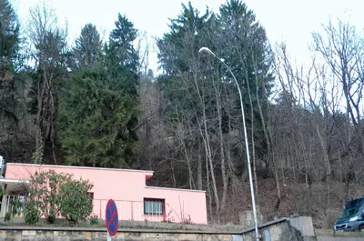 a pink house with a street light in front of it at Studio Jesenice in Jesenice