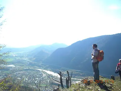 a man standing on top of a mountain looking at a valley at Studio Jesenice in Jesenice