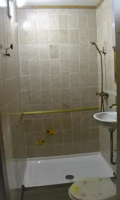 a bathroom with a shower with a toilet and a sink at Studio Jesenice in Jesenice
