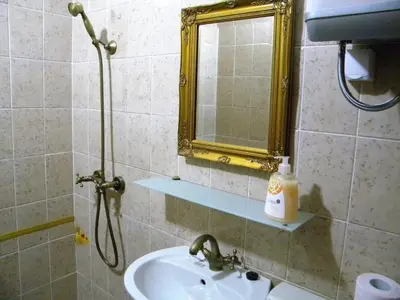 a bathroom with a sink and a mirror at Studio Jesenice in Jesenice