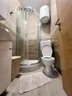 a bathroom with a toilet and a glass shower at Studio apartment Sisters3 in Ljubljana