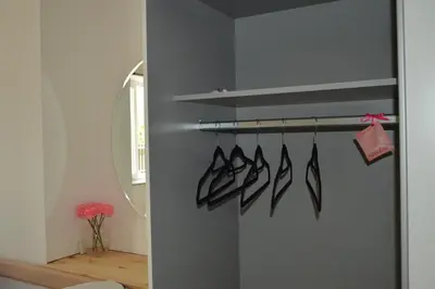 a room with a shelf with several pairs of shoes at Apartment Kancler in Nova Gorica