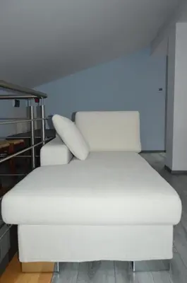 a white couch with two pillows on top of it at Apartment Kancler in Nova Gorica