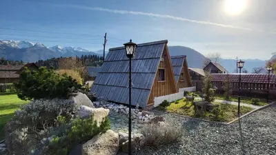 a house with a street light in front of it at Garden ECO houses Čebelica in Bohinj