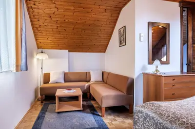 a living room with a couch and a bed at Lake Bled Apartment Zerovec in Bled
