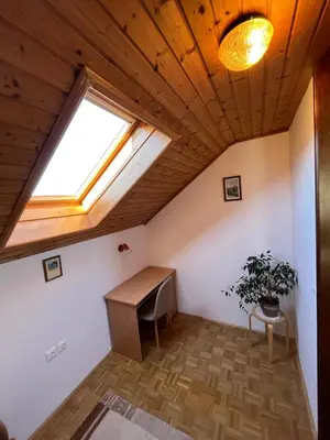 a room with a desk and a window at Lake Bled Apartment Zerovec in Bled
