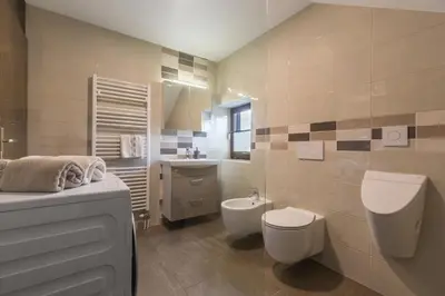 a bathroom with a toilet and a sink at Lake Bled Apartment Zerovec in Bled