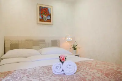 a bedroom with a bed with towels on it at Boutique Hotel Asteria in Ljubljana