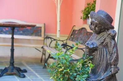 a statue of a woman standing next to a plant at Boutique Hotel Asteria in Ljubljana