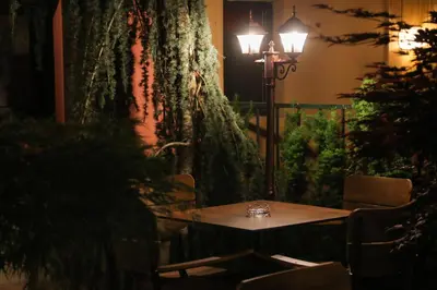 a table in a room with a lamp and a tree at Boutique Hotel Asteria in Ljubljana