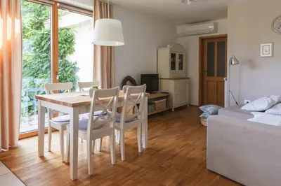a kitchen and living room with a table and chairs at Na Kupčku Estate 