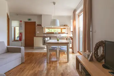 a kitchen and living room with a table and a couch at Na Kupčku Estate 