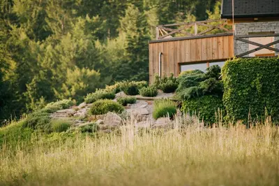 a garden in front of a wooden building at Na Kupčku Estate 