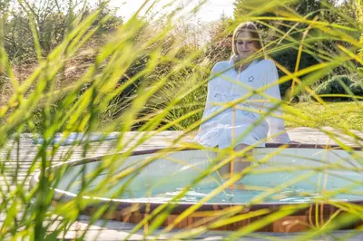 a woman is standing on a boat in a garden at Na Kupčku Estate 