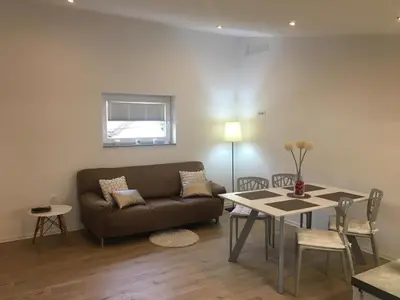 a living room with a couch and a table at Apartments SHISHKA in Ljubljana