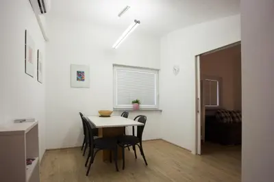 a dining room with a table and chairs in a room at Apartments SHISHKA in Ljubljana