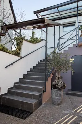 a set of stairs leading up to a house at Apartments SHISHKA in Ljubljana