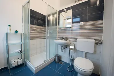 a bathroom with a toilet and a sink and a shower at B&B Vila Teslova in Ljubljana