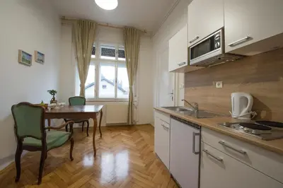 a kitchen with a table and a dining room at B&B Vila Teslova in Ljubljana
