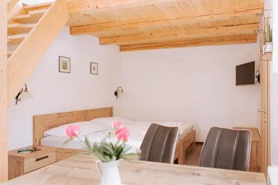 a bedroom with a bed and a table with chairs at Gostišče Krivograd in Prevalje