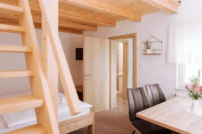 a room with a desk and a table and a staircase at Gostišče Krivograd in Prevalje